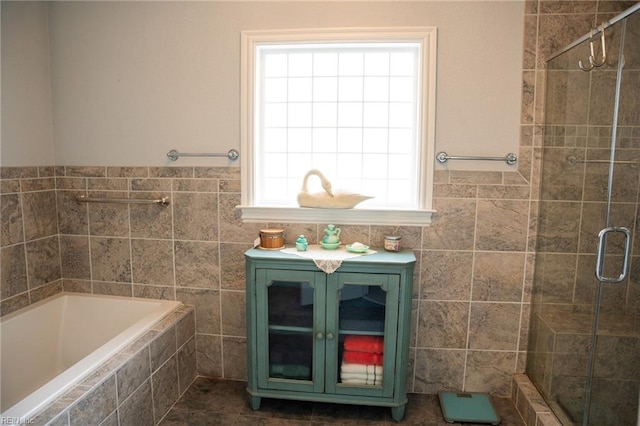 bathroom with tile flooring, a healthy amount of sunlight, and separate shower and tub