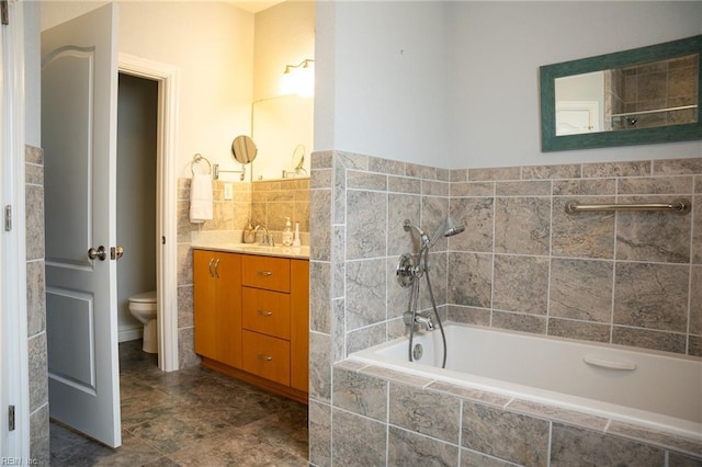 bathroom featuring toilet, tile flooring, vanity, and tile walls