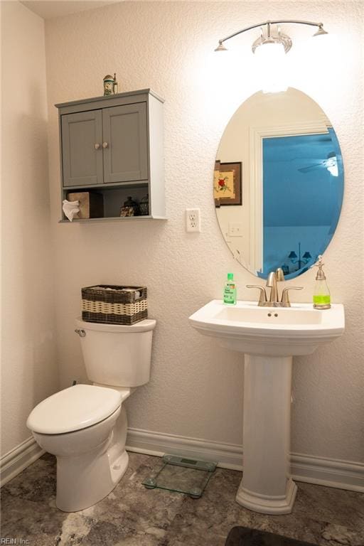 bathroom with tile flooring and toilet