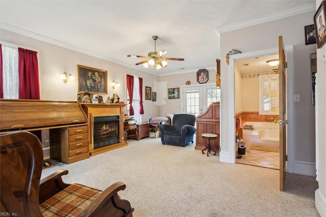 carpeted living room with ceiling fan and crown molding