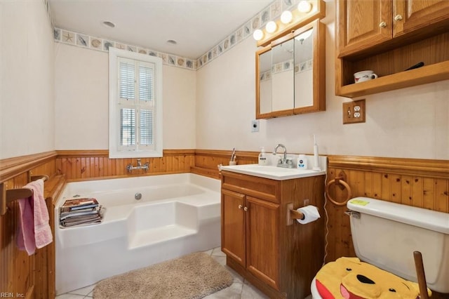 bathroom with a bathing tub, toilet, vanity, and tile flooring