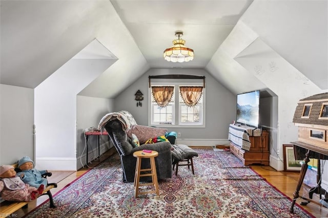 game room with vaulted ceiling and light hardwood / wood-style floors