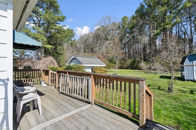 wooden terrace featuring a yard and a storage unit