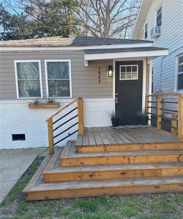 entrance to property with a wooden deck