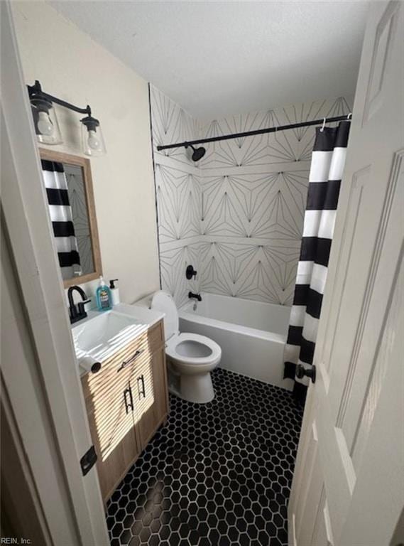 full bathroom with shower / tub combo, toilet, tile flooring, and vanity