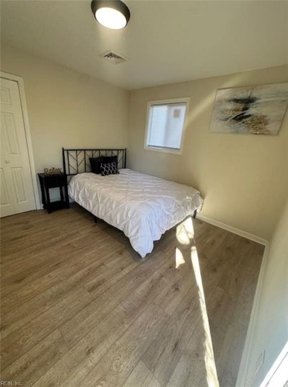 bedroom with wood-type flooring