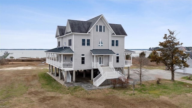 rear view of property featuring a water view