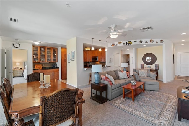 living room featuring ceiling fan and light colored carpet