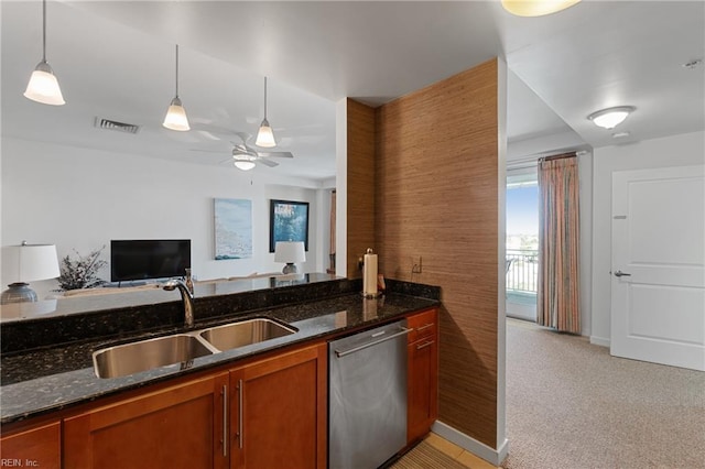 kitchen with light colored carpet, ceiling fan, sink, stainless steel dishwasher, and pendant lighting