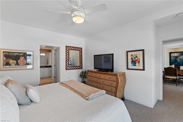 carpeted bedroom with ceiling fan and ensuite bathroom