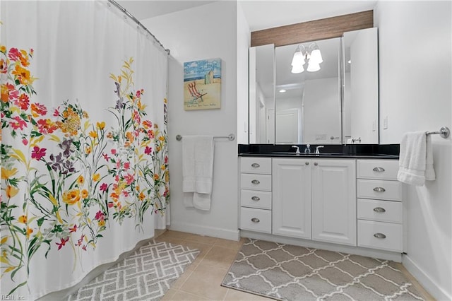 bathroom featuring vanity, tile floors, and a chandelier