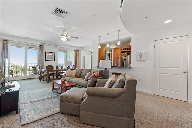 living room with light carpet and ceiling fan