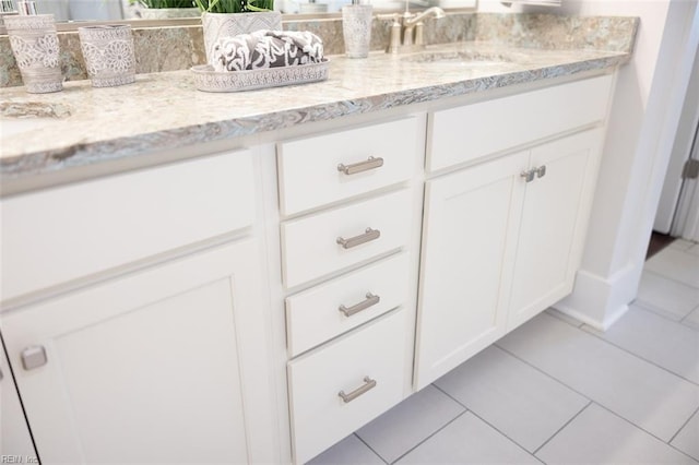 bathroom featuring tile flooring and vanity