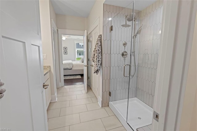 bathroom featuring tile floors, an enclosed shower, and vanity