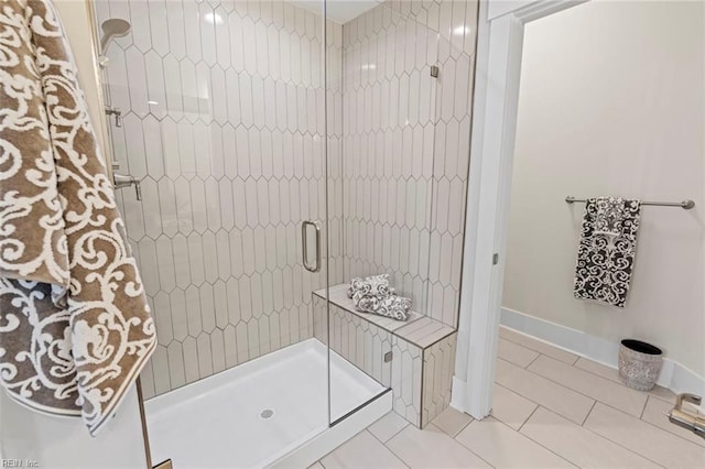 bathroom featuring a shower with door and tile floors