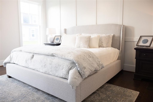 bedroom with dark wood-type flooring