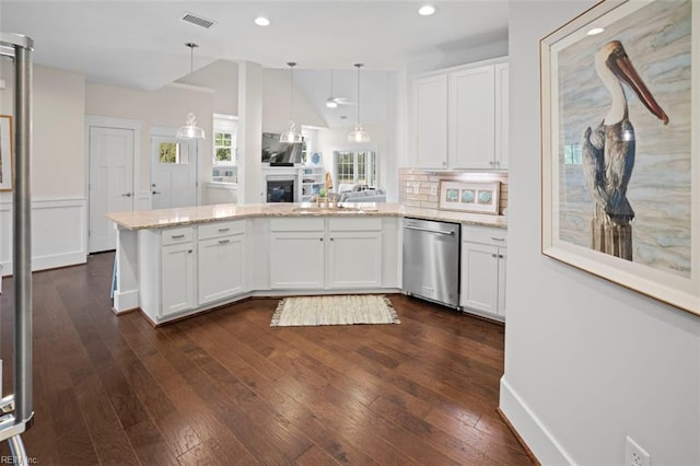 kitchen featuring pendant lighting, stainless steel dishwasher, tasteful backsplash, dark wood-type flooring, and white cabinetry