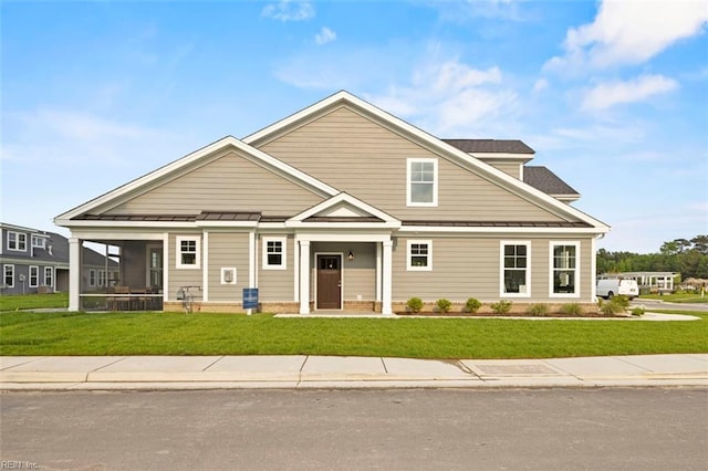 craftsman-style home with a front lawn and a porch