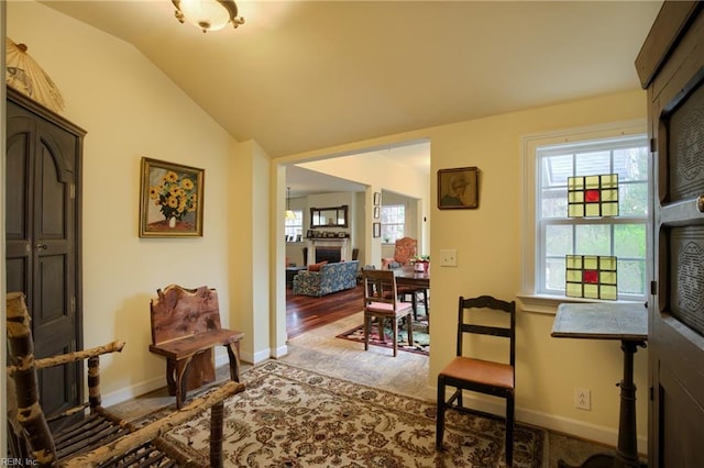 sitting room featuring lofted ceiling and light hardwood / wood-style flooring