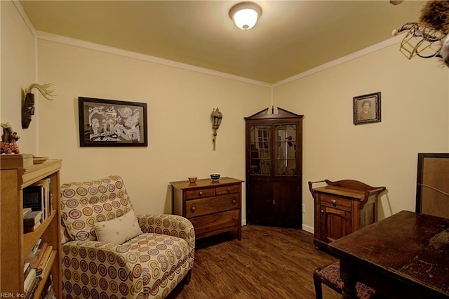 sitting room with crown molding and dark hardwood / wood-style flooring