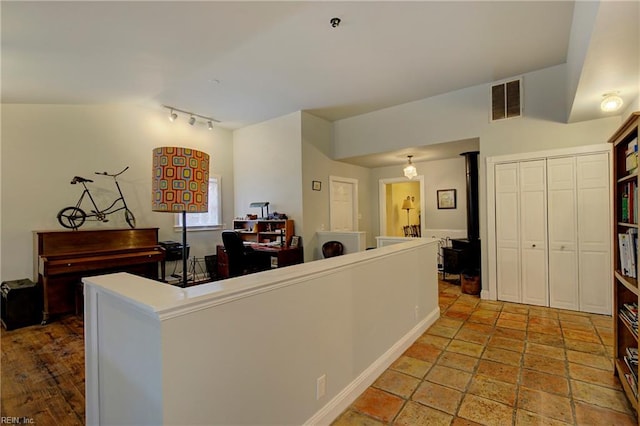 interior space with tile floors and track lighting