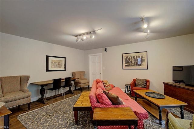 living room with dark wood-type flooring and rail lighting