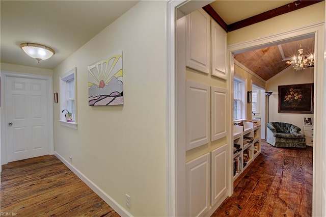 hall with a notable chandelier, lofted ceiling, dark wood-type flooring, and wood ceiling