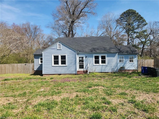 back of house featuring a yard