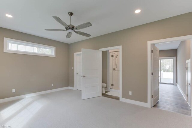 315 Dare Rd, Yorktown, VA 23692 - unfurnished bedroom featuring ceiling fan, light colored carpet, ensuite bath, and multiple windows