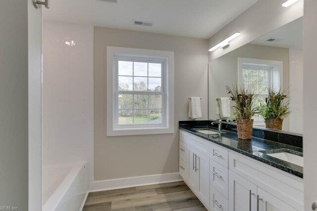 315 Dare Rd, Yorktown, VA 23692 - bathroom with dual vanity, wood-type flooring, and a healthy amount of sunlight