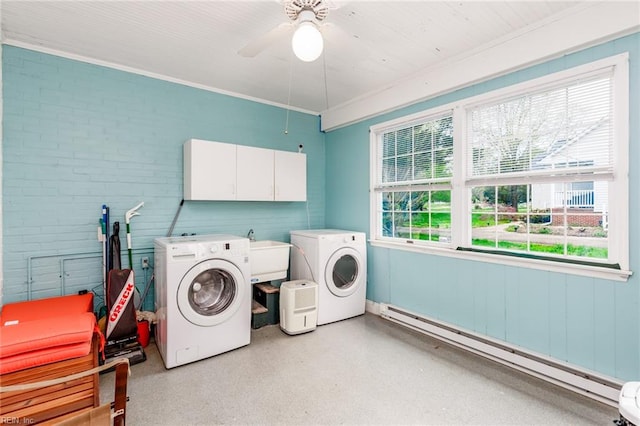 laundry area with independent washer and dryer, ceiling fan, sink, a baseboard heating unit, and cabinets