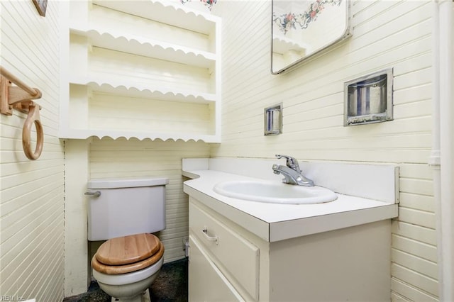 bathroom featuring vanity with extensive cabinet space and toilet