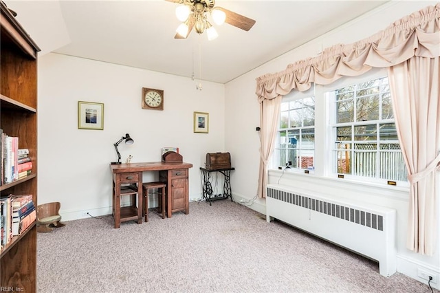 interior space with light carpet, ceiling fan, and radiator heating unit