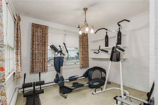 workout room featuring a chandelier, light colored carpet, ornamental molding, and a baseboard heating unit