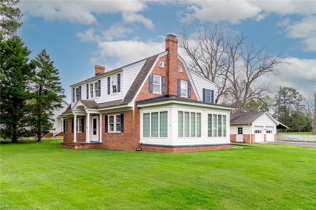 back of property with a lawn and a garage