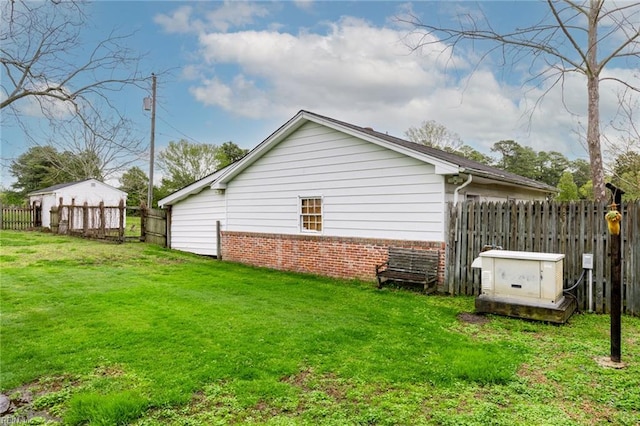 view of home's exterior featuring a yard and a storage shed