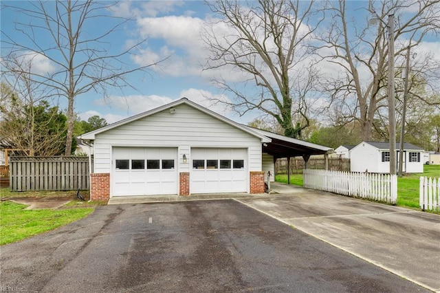 garage with a lawn and a carport