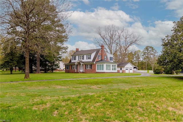 view of front of property featuring a front lawn and a garage