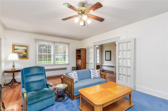 living room featuring crown molding, ceiling fan, and radiator