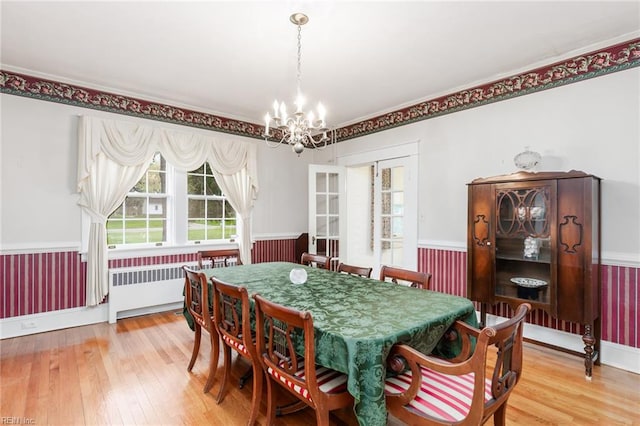 dining area with a chandelier and light hardwood / wood-style floors