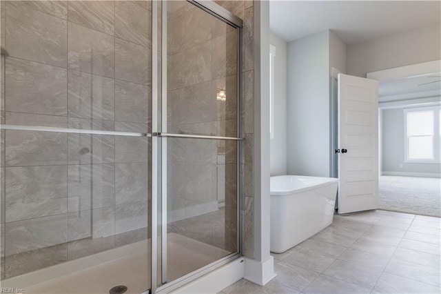 bathroom with tile flooring and an enclosed shower