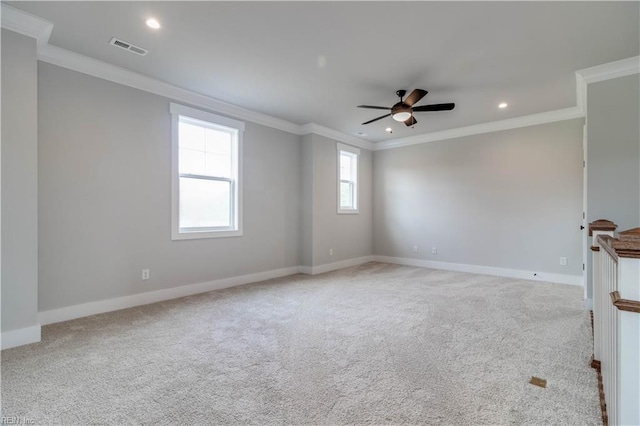 spare room with light carpet, crown molding, and ceiling fan