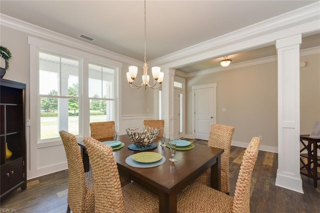 dining space with crown molding, a notable chandelier, and dark hardwood / wood-style floors