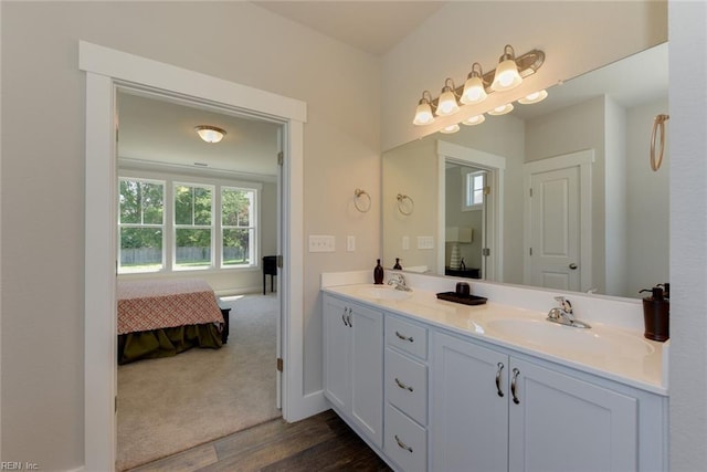 bathroom featuring double vanity and hardwood / wood-style flooring