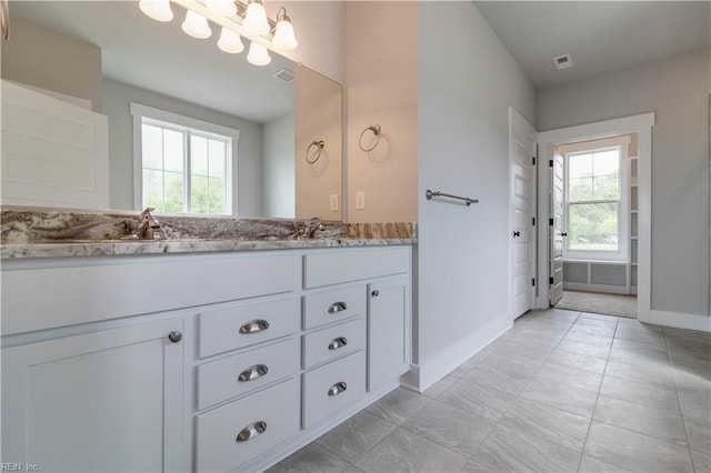 bathroom featuring double sink vanity and tile flooring