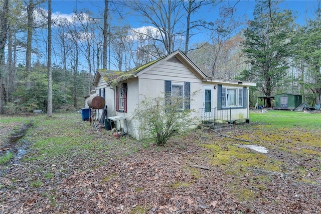 view of side of home featuring a yard