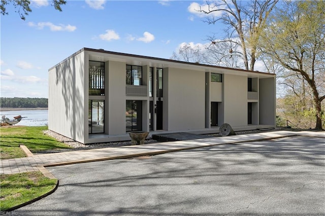 exterior space featuring a balcony and a water view