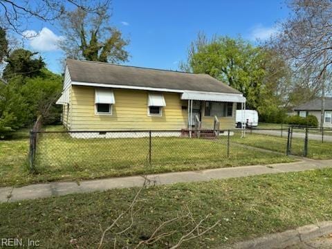 view of side of home with a yard