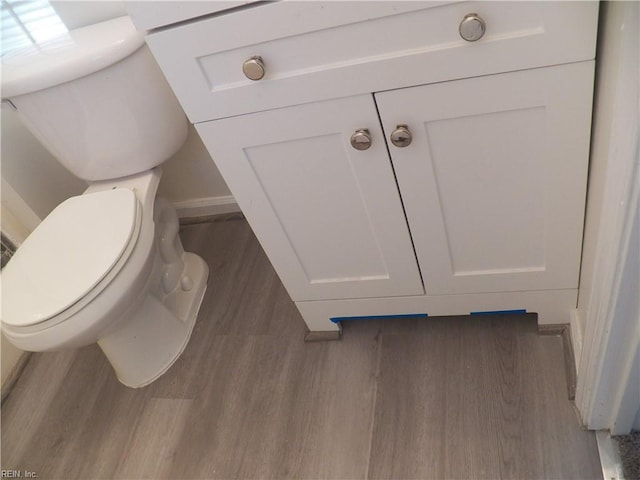 bathroom with vanity, hardwood / wood-style flooring, and toilet