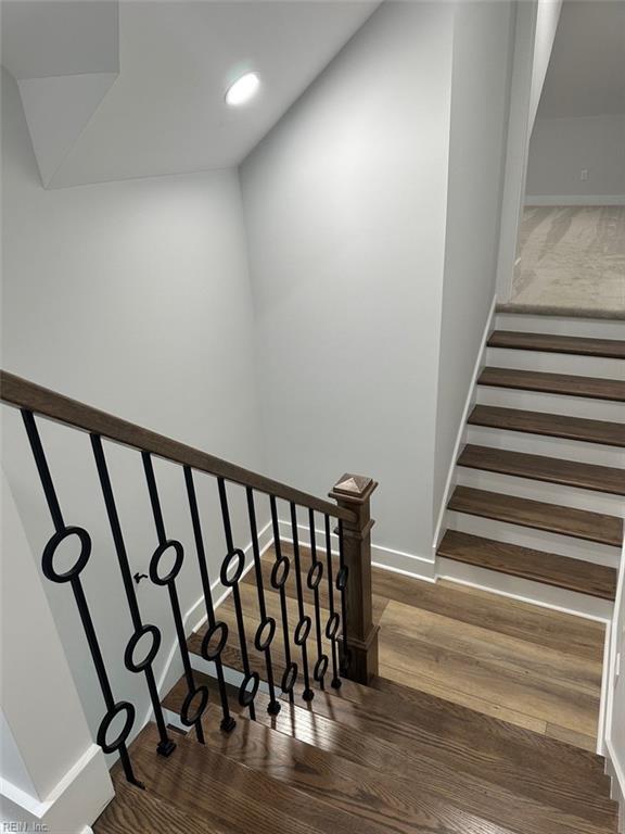 staircase featuring hardwood / wood-style flooring